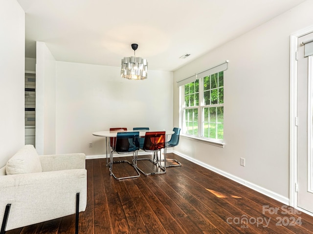 dining room featuring an inviting chandelier and dark hardwood / wood-style flooring