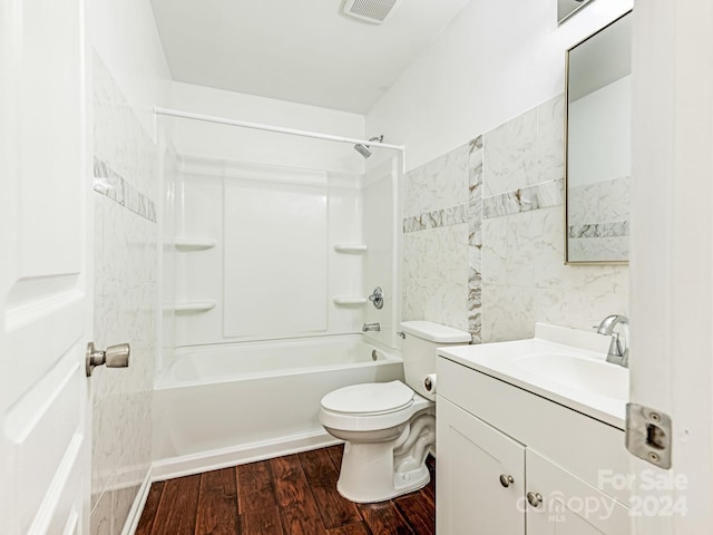 full bathroom with hardwood / wood-style flooring, toilet, vanity, and shower / bathing tub combination