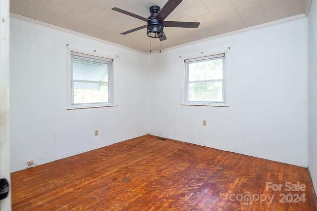 spare room with hardwood / wood-style floors, ceiling fan, and crown molding