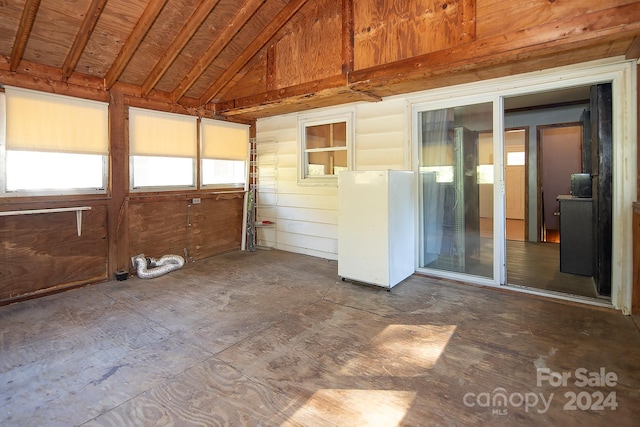 unfurnished sunroom featuring lofted ceiling