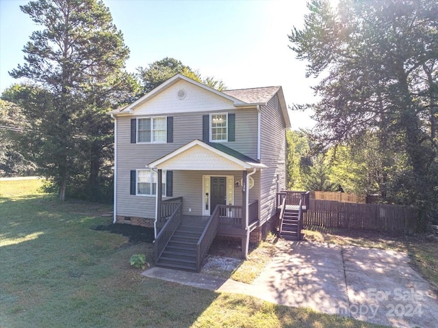 view of front of home with a porch and a front yard