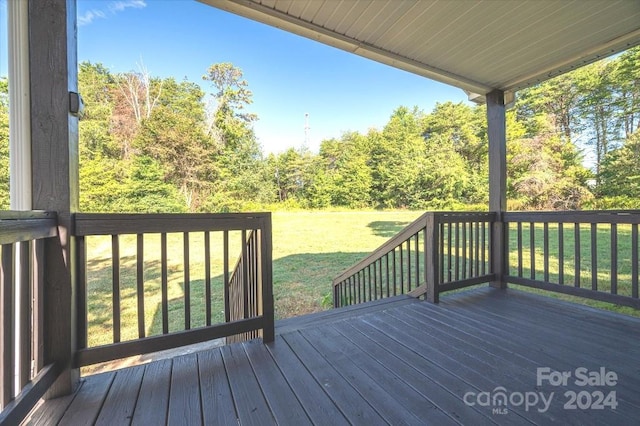 wooden deck featuring a yard