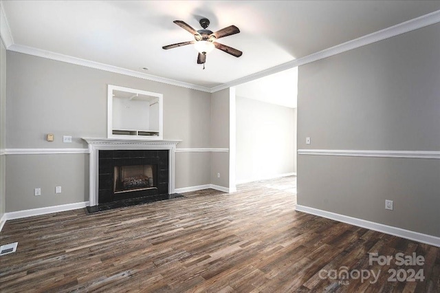 unfurnished living room featuring ornamental molding, a fireplace, ceiling fan, and dark wood-type flooring