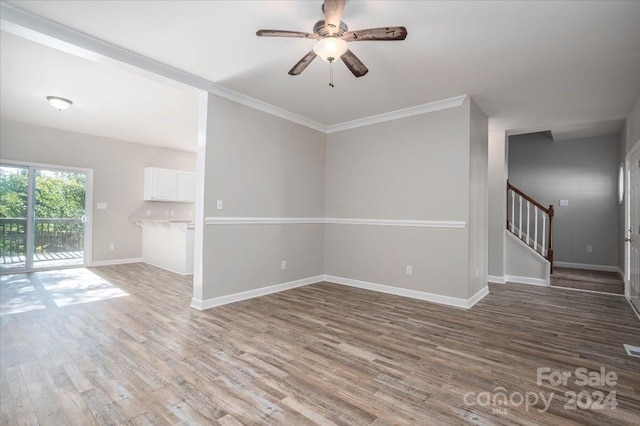 unfurnished room with ceiling fan, ornamental molding, and hardwood / wood-style floors