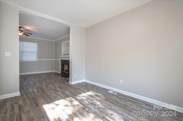 unfurnished living room featuring ceiling fan, ornamental molding, and dark hardwood / wood-style flooring