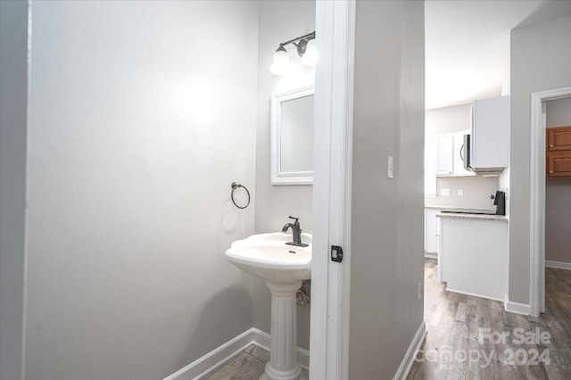 bathroom with hardwood / wood-style floors