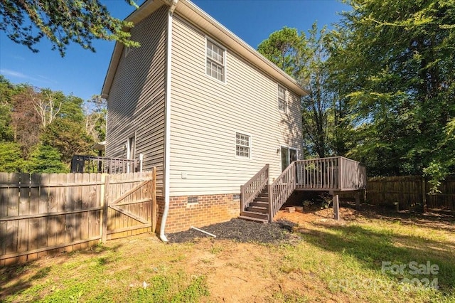 exterior space featuring a deck and a lawn