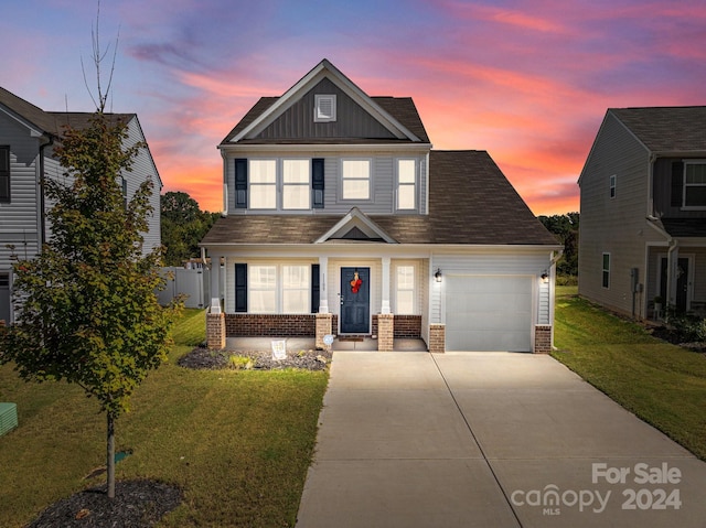 traditional-style home with a garage, driveway, board and batten siding, and brick siding