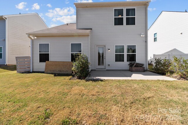 back of property featuring a yard and a patio