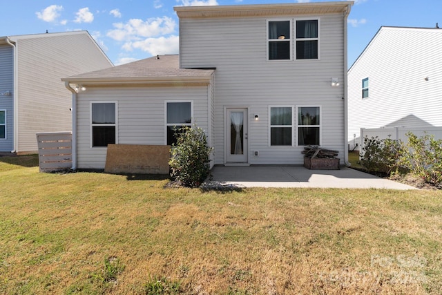 rear view of property with a lawn, fence, and a patio