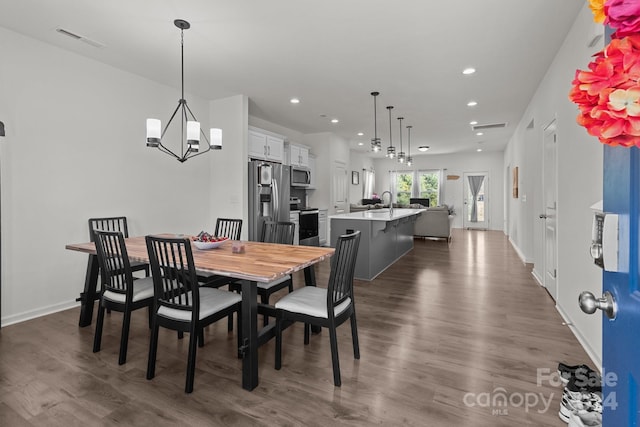 dining area featuring baseboards, dark wood-type flooring, visible vents, and recessed lighting