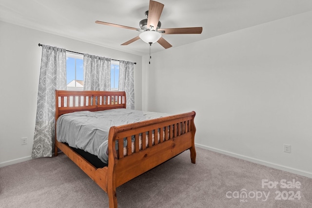 carpeted bedroom featuring baseboards and ceiling fan