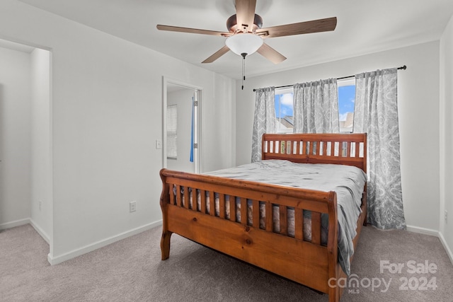 bedroom with ceiling fan and light colored carpet