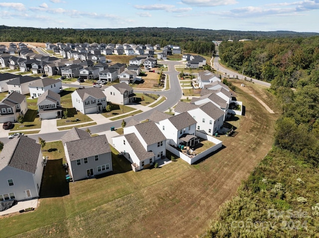 aerial view with a wooded view and a residential view