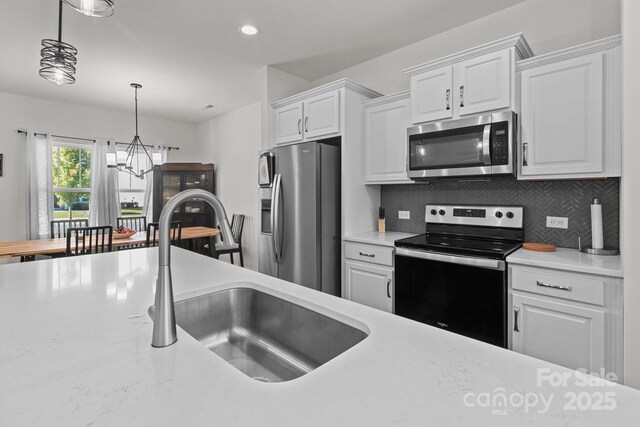 1109 Freeman View Dr, Albemarle, NC 28001 - kitchen with stainless steel appliances, light countertops, a chandelier, white cabinets, and recessed lighting