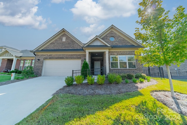 view of front of house with a front yard and a garage