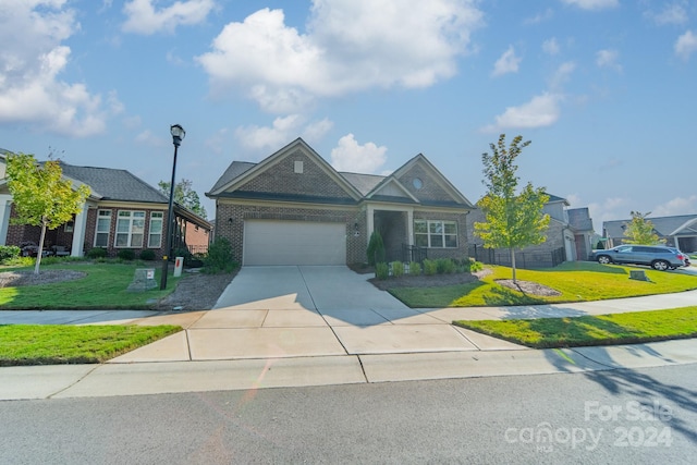 view of front of property with a front yard and a garage