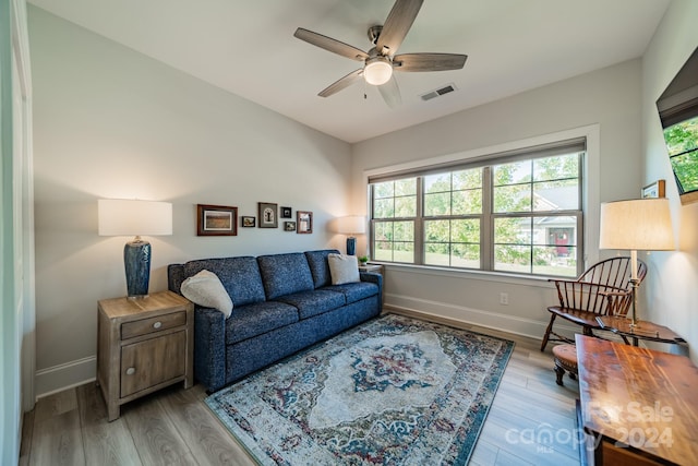 living room with ceiling fan, a healthy amount of sunlight, and light hardwood / wood-style flooring