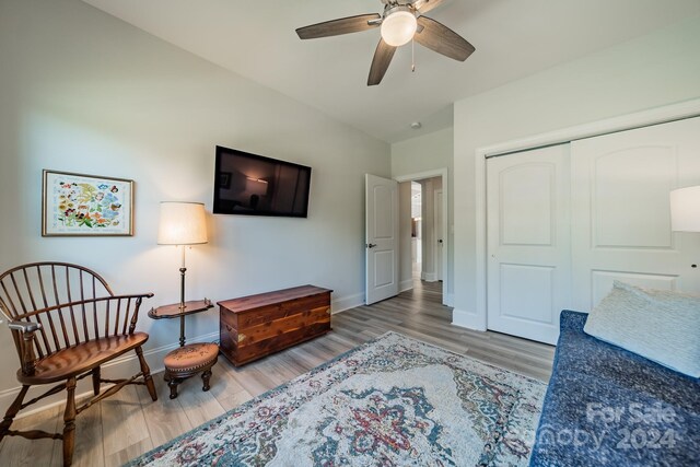 sitting room with ceiling fan and hardwood / wood-style floors