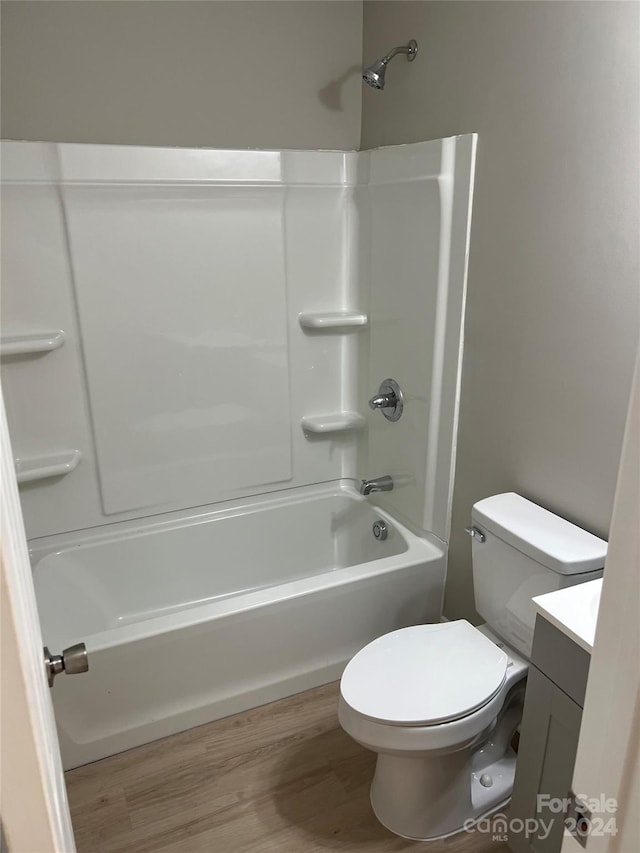 full bathroom featuring vanity, hardwood / wood-style flooring, toilet, and tub / shower combination