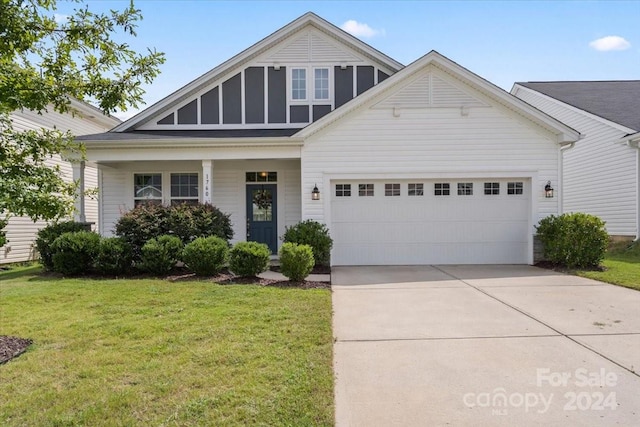 view of front of property with a garage and a front lawn