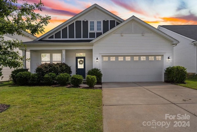 view of front facade featuring a garage and a lawn