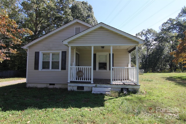 bungalow-style home featuring a front lawn and covered porch