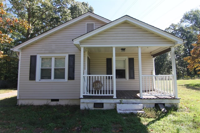 bungalow-style home with a front yard and a porch