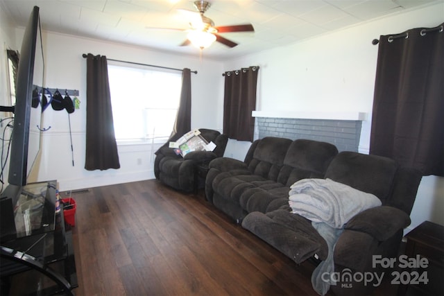 living room featuring ceiling fan and dark hardwood / wood-style floors