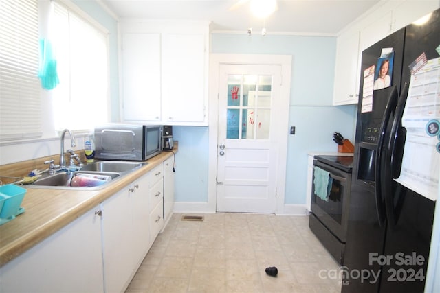 kitchen featuring ornamental molding, black appliances, sink, and white cabinets