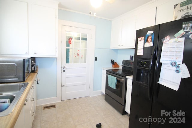 kitchen with ornamental molding, white cabinets, black appliances, and sink