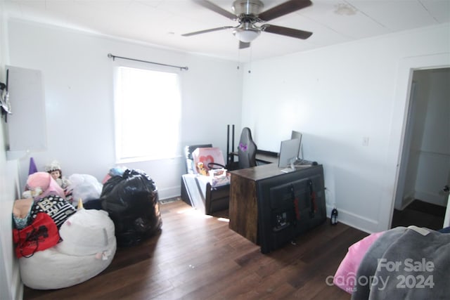 home office with dark wood-type flooring and ceiling fan