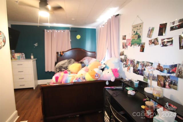 bedroom with ceiling fan, crown molding, and dark wood-type flooring