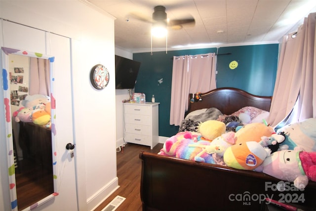 bedroom featuring ceiling fan, dark hardwood / wood-style floors, and ornamental molding