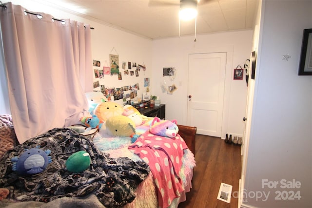 bedroom with ceiling fan and dark wood-type flooring