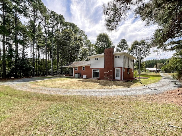 view of property exterior with a yard