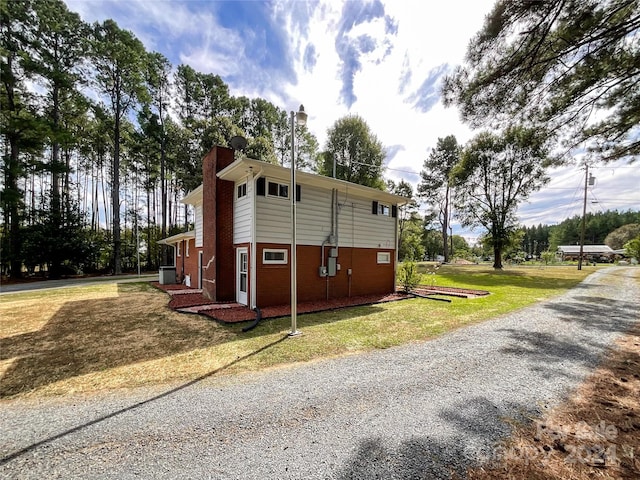 view of side of property with a yard