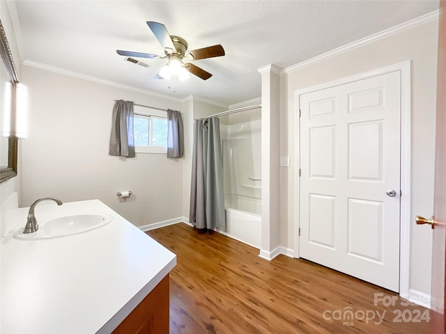 bathroom with crown molding, hardwood / wood-style floors, and vanity