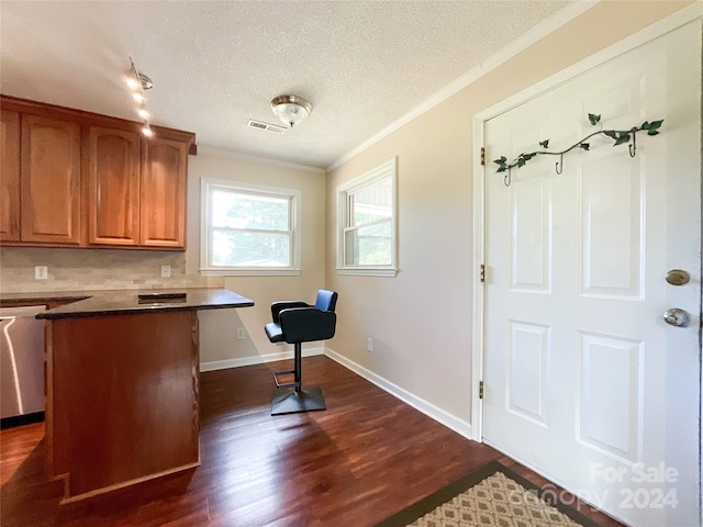 interior space with decorative backsplash, dark hardwood / wood-style floors, ornamental molding, stainless steel dishwasher, and a textured ceiling