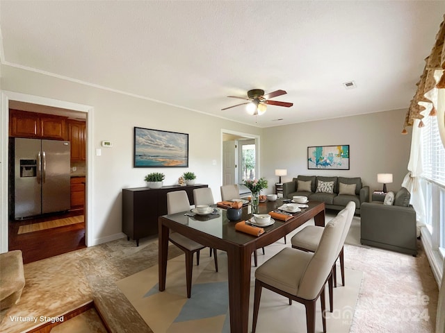 dining room with ceiling fan, ornamental molding, light hardwood / wood-style floors, and a wealth of natural light