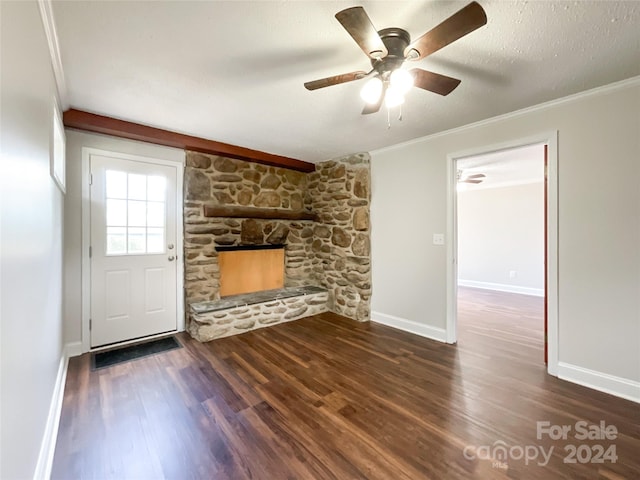 unfurnished living room featuring ceiling fan, dark hardwood / wood-style flooring, a fireplace, ornamental molding, and a textured ceiling