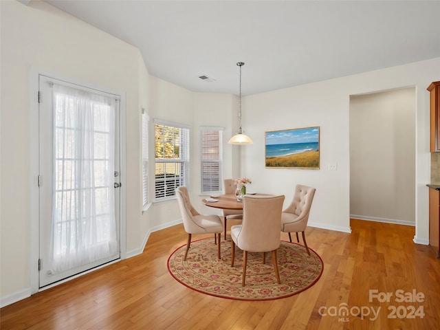 dining space with light hardwood / wood-style floors