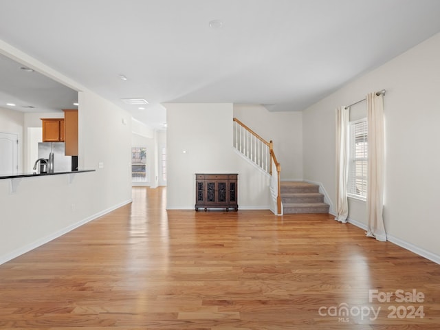 unfurnished living room with light wood-type flooring