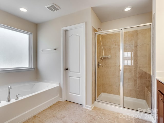 bathroom featuring vanity, tile patterned floors, and independent shower and bath