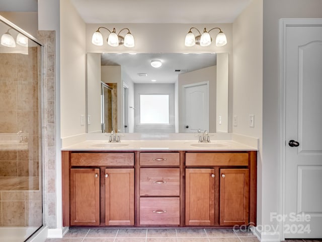 bathroom featuring vanity, tile patterned floors, and an enclosed shower