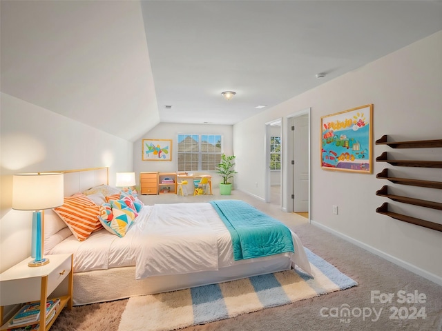 carpeted bedroom with vaulted ceiling