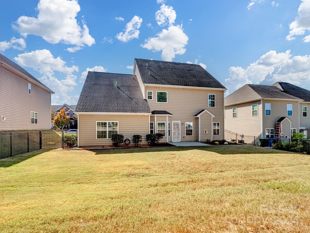 rear view of house featuring a patio and a lawn