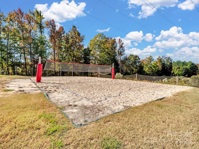 view of home's community with a lawn and volleyball court