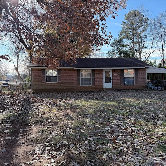 view of front of property with brick siding and fence