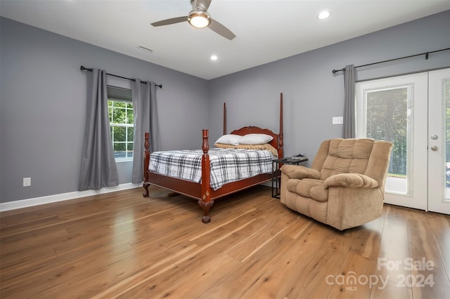 bedroom with access to outside, multiple windows, ceiling fan, and hardwood / wood-style flooring